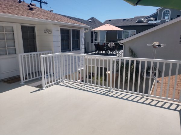 White railing around a coated patio deck